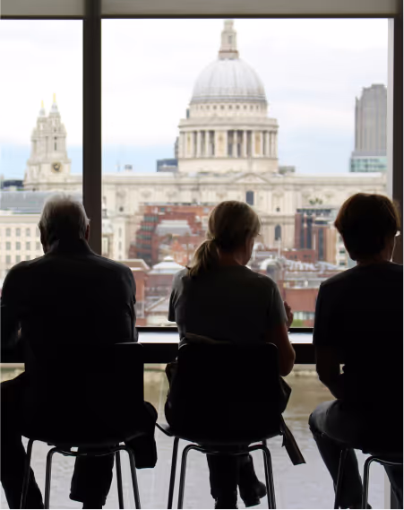 People sitting and looking outside of a window