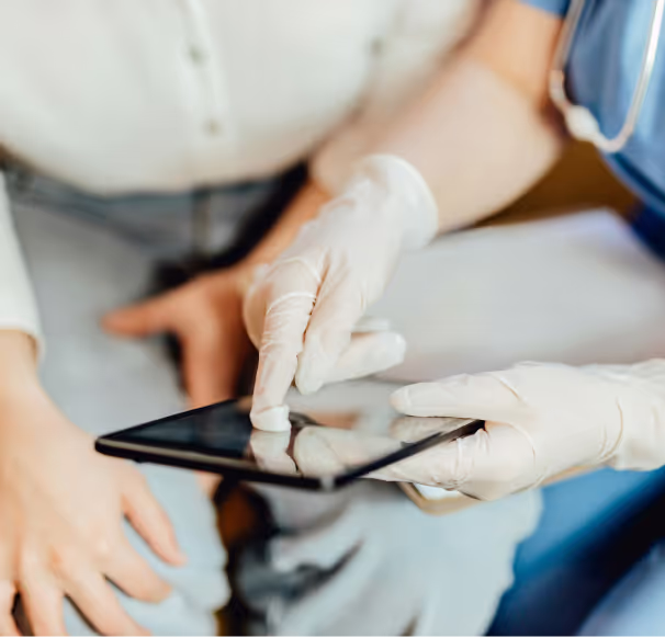 A healthcare worker interacting with a tablet
